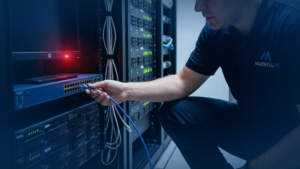 An IT professional disconnecting a network cable from a server to stop the spread of malware, a key step in ransomware attack recovery.